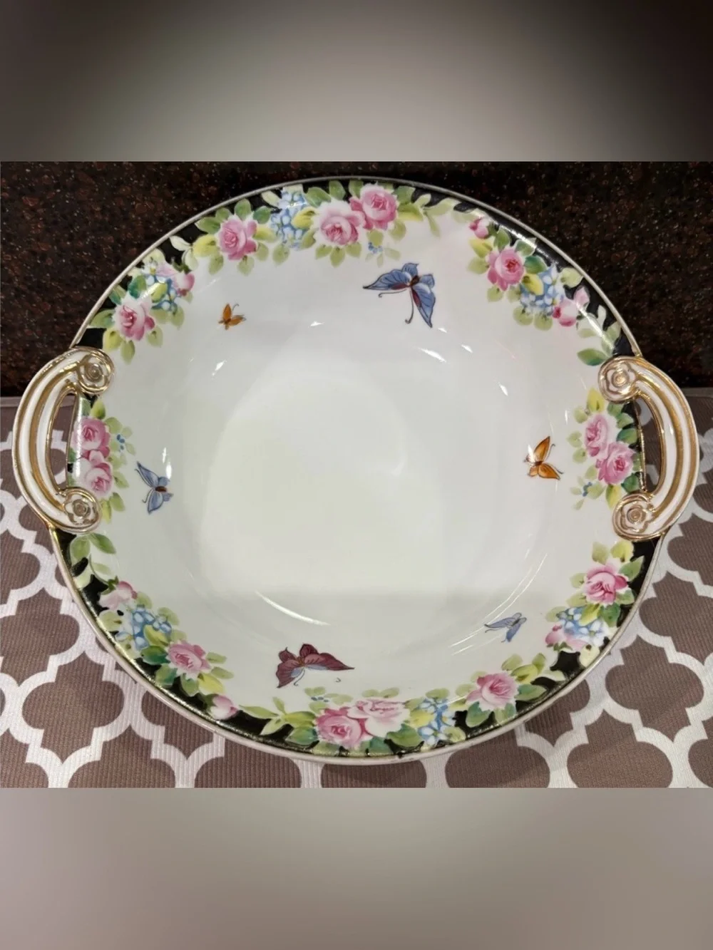Nippon Hand-painted bowl featuring a floral motif & butterflies with gold trim